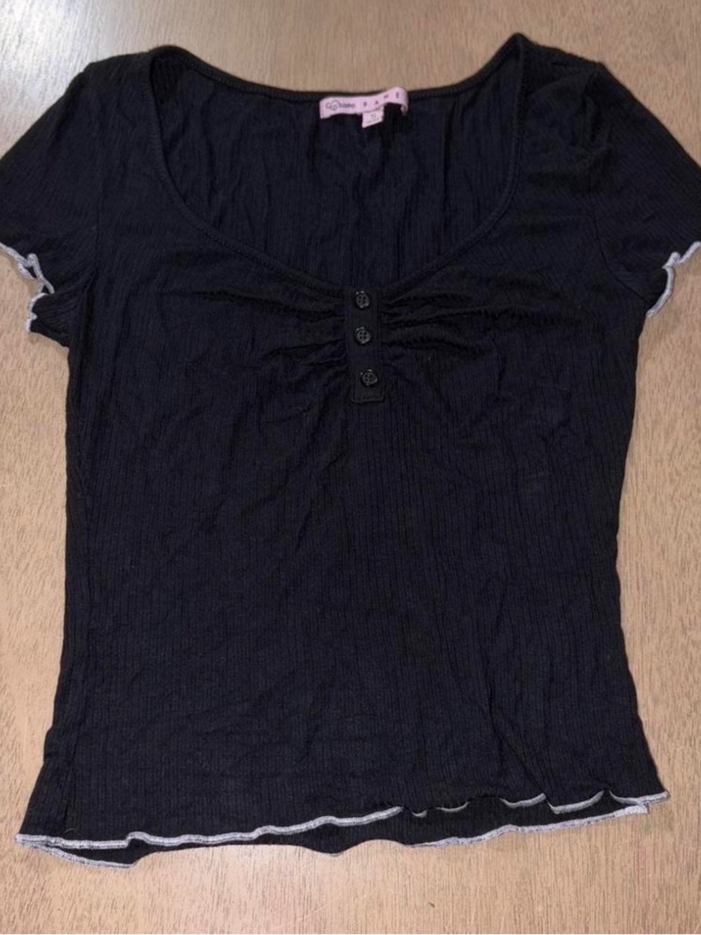 Black top with white trim and button detail